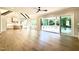 Living room showcasing hardwood floors, access to outdoor deck and open concept kitchen at 5820 Shawood Dr, Raleigh, NC 27609