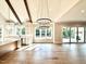Bright living room with hardwood floors, modern lighting, and an open kitchen concept at 5820 Shawood Dr, Raleigh, NC 27609