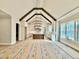 Open-concept room with vaulted ceiling, wood beams, modern light fixture, and views of the kitchen at 5820 Shawood Dr, Raleigh, NC 27609