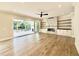 Bright living room with fireplace, hardwood floors, and large sliding doors leading to the deck at 5820 Shawood Dr, Raleigh, NC 27609