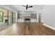 Bright living room with sliding glass doors to back porch, fireplace, built-in shelves, and hardwood flooring at 5820 Shawood Dr, Raleigh, NC 27609