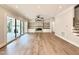 Open living room features a fireplace, hardwood floors, and sliding glass doors to outdoor patio at 5820 Shawood Dr, Raleigh, NC 27609