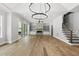 Open concept living room features hardwood flooring, fireplace, built-in shelves, and staircase at 5820 Shawood Dr, Raleigh, NC 27609
