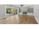 Living room features hardwood flooring, large sliding glass doors to back porch, built-in shelves, and fireplace at 5820 Shawood Dr, Raleigh, NC 27609
