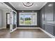 A formal living room with decorative molding, chandelier, hardwood floors, and natural light at 5820 Shawood Dr, Raleigh, NC 27609