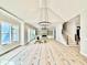 Spacious, light filled living room with fireplace, built-ins, sliding glass doors, and staircase at 5820 Shawood Dr, Raleigh, NC 27609