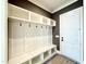 Mudroom area features shelving, coat hooks, and a bench at 5820 Shawood Dr, Raleigh, NC 27609
