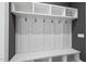 Mudroom featuring white cubbies, hooks, and shelving for storage and organization at 5820 Shawood Dr, Raleigh, NC 27609