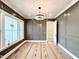 Finished office featuring paneled walls, elegant lighting, and a large window at 5820 Shawood Dr, Raleigh, NC 27609