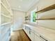 Walk-in pantry with white marble counters and wood shelving and floors at 5820 Shawood Dr, Raleigh, NC 27609
