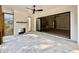 View of a bright outdoor patio featuring a ceiling fan, fireplace, and sliding glass doors at 5820 Shawood Dr, Raleigh, NC 27609