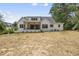 A spacious back yard and covered patio enhance the rear of this modern white home at 5820 Shawood Dr, Raleigh, NC 27609