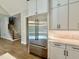 Stainless steel refrigerator and white cabinets located by stairs at 5820 Shawood Dr, Raleigh, NC 27609