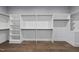 Spacious walk-in closet with custom shelving and wood floors at 5820 Shawood Dr, Raleigh, NC 27609