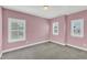 Cozy bedroom with pink walls and multiple windows at 6134 Giddings St, Raleigh, NC 27616