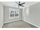 Spacious bedroom with ceiling fan and grey carpeting at 6134 Giddings St, Raleigh, NC 27616