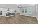 Modern kitchen with white cabinets, large island, and stainless steel appliances at 6134 Giddings St, Raleigh, NC 27616