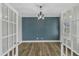 Small office with dark blue accent wall and hardwood floors at 6134 Giddings St, Raleigh, NC 27616