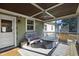 Relaxing screened porch with white wicker furniture and ceiling fan at 717 Dorothea Dr, Raleigh, NC 27603