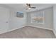 Well-lit bedroom with a mounted TV and window views at 72 Florentino Ct, Clayton, NC 27527