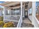 Inviting front porch with white railing and stone steps at 72 Florentino Ct, Clayton, NC 27527