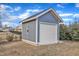 Gray storage shed with white garage door in backyard at 72 Florentino Ct, Clayton, NC 27527