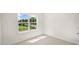 Well-lit bedroom featuring a large window and carpet at 8619 Brixton Shay Dr, Raleigh, NC 27616