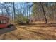 Yard with shed and wooded area beyond at 9 Misty Creek Ct, Durham, NC 27705