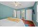 Well-lit bedroom with teal walls, hardwood floors and ensuite bathroom at 9 Misty Creek Ct, Durham, NC 27705