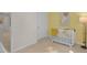 Bright Bedroom featuring a white crib, soft carpeting, and decorative yellow accent wall at 908 Canis Minor Rd, Wendell, NC 27591