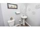 Clean bathroom with pedestal sink and decorative wall art at 98 Panmure, Rocky Mount, NC 27804