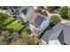 Aerial view of a blue two-story home showcasing the fenced yard and solar panels at 1000 Norris St, Raleigh, NC 27604