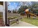 Backyard play area featuring a play structure, raised garden bed and string lights overhead at 1000 Norris St, Raleigh, NC 27604