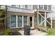 Outdoor patio area with a grill, greenery, and a basement walk-out door at 1000 Norris St, Raleigh, NC 27604