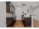 Compact bar area with dark wood cabinets, stylish pendant lighting, and modern appliances at 1000 Norris St, Raleigh, NC 27604