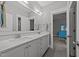 Stylish bathroom with a double sink vanity, granite countertop, and large mirror, providing ample space at 1000 Norris St, Raleigh, NC 27604