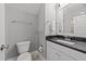 Simple bathroom with toilet and single sink vanity with dark countertop at 1000 Norris St, Raleigh, NC 27604