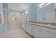 Bright bathroom features double vanity, neutral counters and a large glass enclosed shower at 1000 Norris St, Raleigh, NC 27604