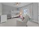 Bright bedroom featuring a bunk bed, soft carpet, and a cozy reading nook with natural light at 1000 Norris St, Raleigh, NC 27604