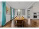 Elegant dining room with a modern chandelier, hardwood floors, and natural light at 1000 Norris St, Raleigh, NC 27604
