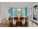 Elegant dining room with a modern chandelier, hardwood floors, and natural light at 1000 Norris St, Raleigh, NC 27604