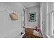 Functional entryway with bench, hooks, hardwood floors, and bright natural light at 1000 Norris St, Raleigh, NC 27604