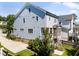 Side exterior of a charming blue home with well-maintained landscaping and a rear porch at 1000 Norris St, Raleigh, NC 27604