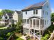 Rear exterior of a beautiful blue home featuring a screened-in porch and solar panels at 1000 Norris St, Raleigh, NC 27604
