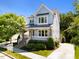 Charming two-story home with a welcoming front porch and professionally landscaped front yard at 1000 Norris St, Raleigh, NC 27604