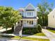 Charming two-story home with a welcoming front porch and professionally landscaped front yard at 1000 Norris St, Raleigh, NC 27604
