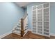 Hallway with stairs leading up, display cabinet and beautiful flooring at 1000 Norris St, Raleigh, NC 27604