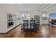 Spacious kitchen with stainless appliances, white cabinetry, island seating, and view to living area at 1000 Norris St, Raleigh, NC 27604