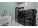 Functional laundry room with modern washer, dryer, and ample storage space, designed for convenience at 1000 Norris St, Raleigh, NC 27604