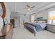 Spacious main bedroom with a tray ceiling, carpeted floor, and ensuite bathroom with large windows at 1000 Norris St, Raleigh, NC 27604